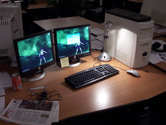 Desk with two flatscreens showing a Mononoke Hime wallpaper